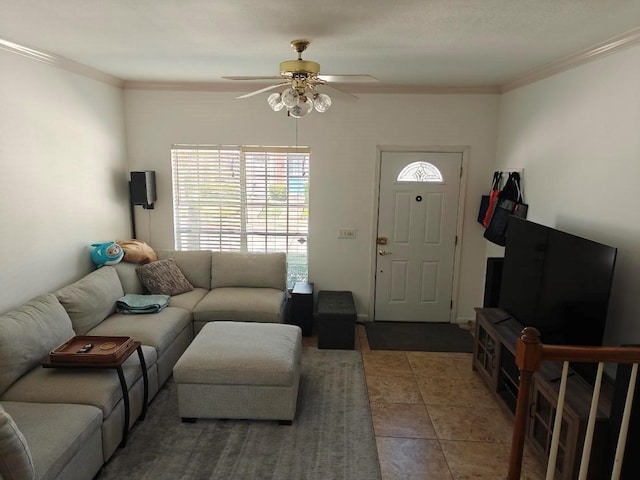 living room featuring tile patterned floors, ceiling fan, and ornamental molding