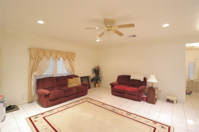 living room featuring light tile patterned floors and ceiling fan