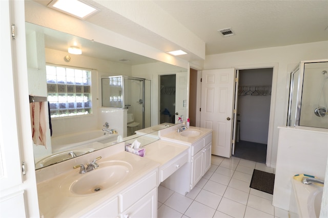 bathroom with tile patterned flooring, vanity, and independent shower and bath