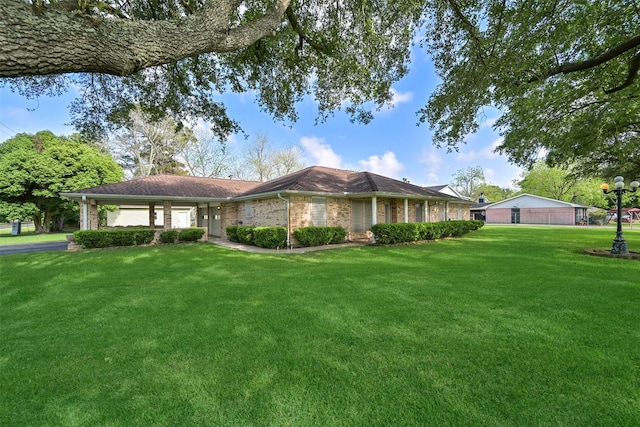 102 N Noble Rd, Texas City, TX 77591 - ranch-style home with a front yard, brick siding, an attached garage, and driveway