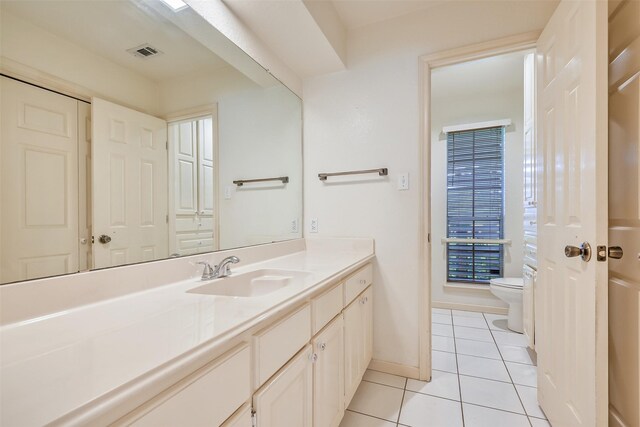 102 N Noble Rd, Texas City, TX 77591 - bathroom featuring toilet, tile patterned floors, vanity, and baseboards