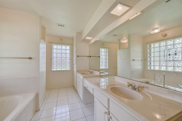 102 N Noble Rd, Texas City, TX 77591 - full bath featuring double vanity, a garden tub, tile patterned flooring, a textured ceiling, and baseboards