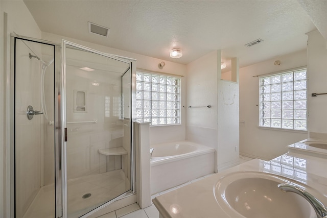 102 N Noble Rd, Texas City, TX 77591 - full bath with a garden tub, a shower stall, vanity, healthy amount of natural light, and a textured ceiling