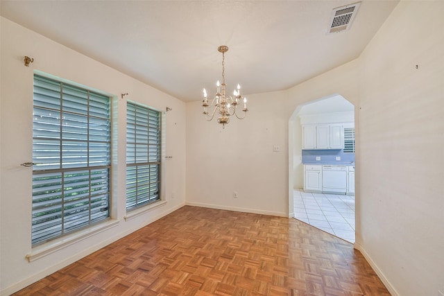 102 N Noble Rd, Texas City, TX 77591 - unfurnished room featuring a chandelier, baseboards, and arched walkways