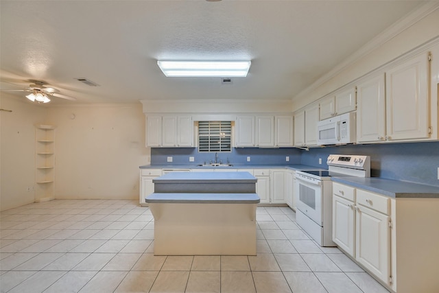 102 N Noble Rd, Texas City, TX 77591 - kitchen with white appliances, a sink, light tile patterned flooring, white cabinets, and crown molding