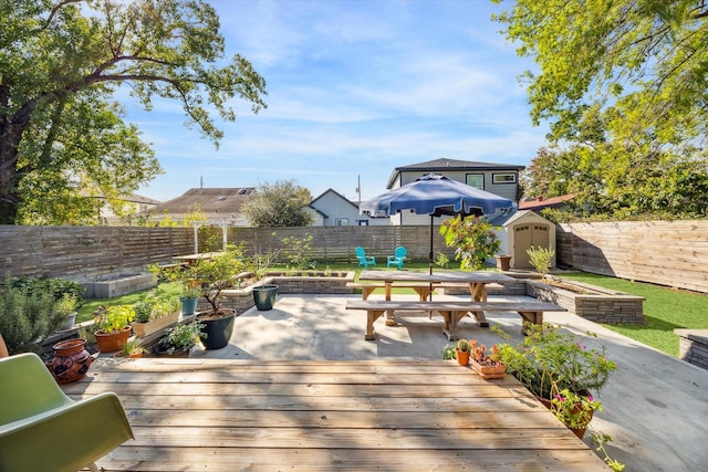 view of patio / terrace with a shed and a deck