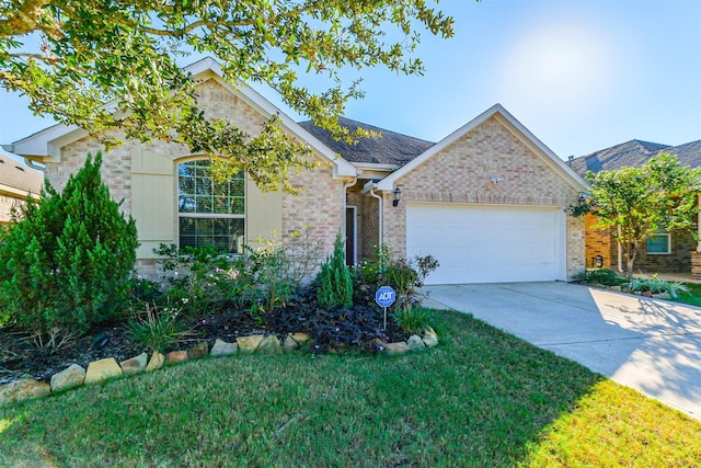 view of front of home featuring a garage and a front lawn