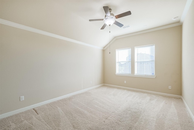 carpeted spare room with ceiling fan, lofted ceiling, and ornamental molding