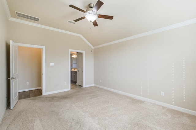 unfurnished bedroom with ensuite bath, light colored carpet, vaulted ceiling, and ornamental molding