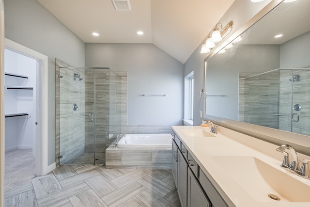 bathroom featuring vanity, plus walk in shower, and lofted ceiling