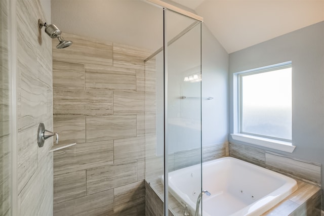 bathroom with shower with separate bathtub and vaulted ceiling