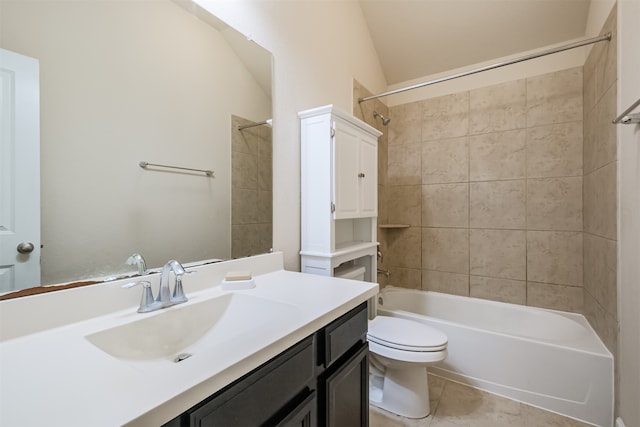 full bathroom with tile patterned floors, vaulted ceiling, toilet, vanity, and tiled shower / bath