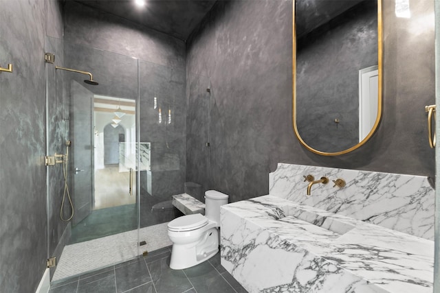 bathroom featuring toilet, walk in shower, and tile patterned floors