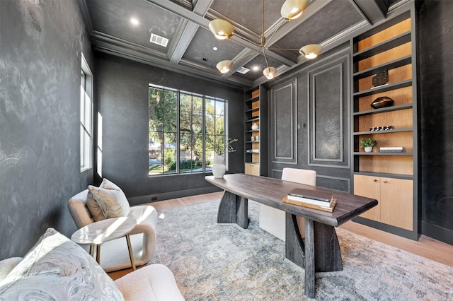 office featuring coffered ceiling, built in shelves, crown molding, and beam ceiling