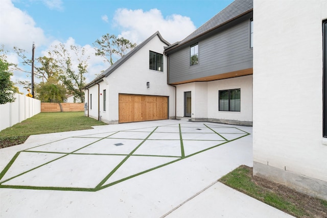 back of house featuring a yard and a garage