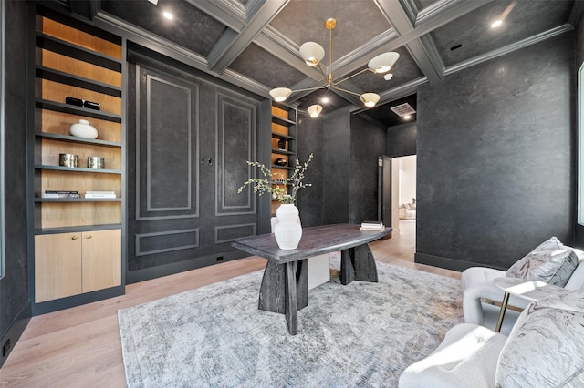 home office with beamed ceiling, light wood-type flooring, built in features, coffered ceiling, and crown molding