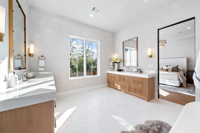 bathroom with vanity and parquet floors