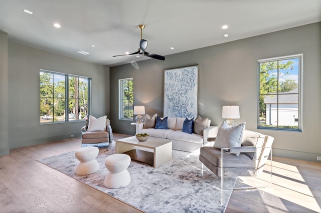 living room with ceiling fan and light hardwood / wood-style floors