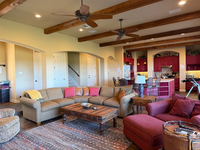 living room with beamed ceiling and ceiling fan