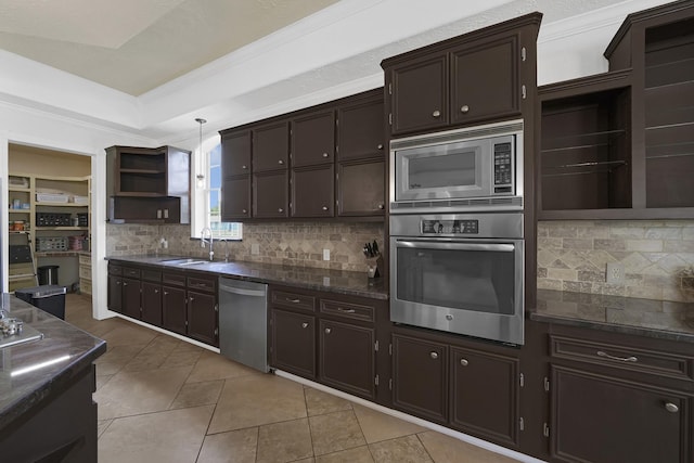 kitchen with pendant lighting, sink, tasteful backsplash, dark brown cabinets, and stainless steel appliances