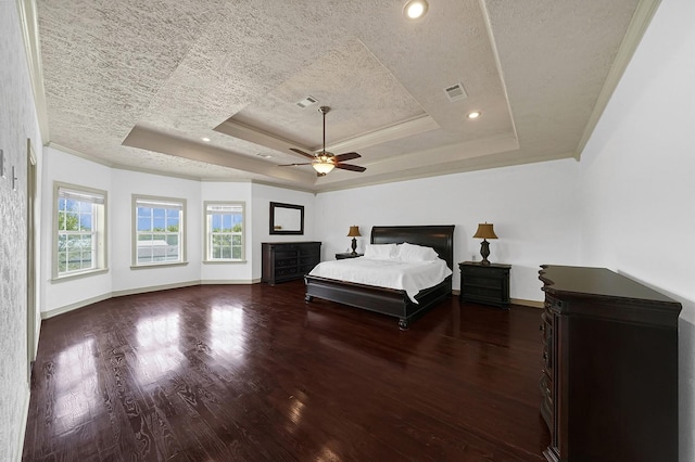 unfurnished bedroom with a textured ceiling, a raised ceiling, ceiling fan, and dark wood-type flooring