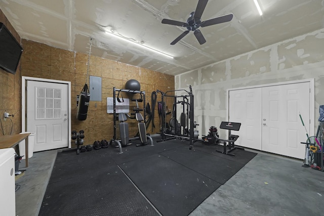 workout area with electric panel and ceiling fan