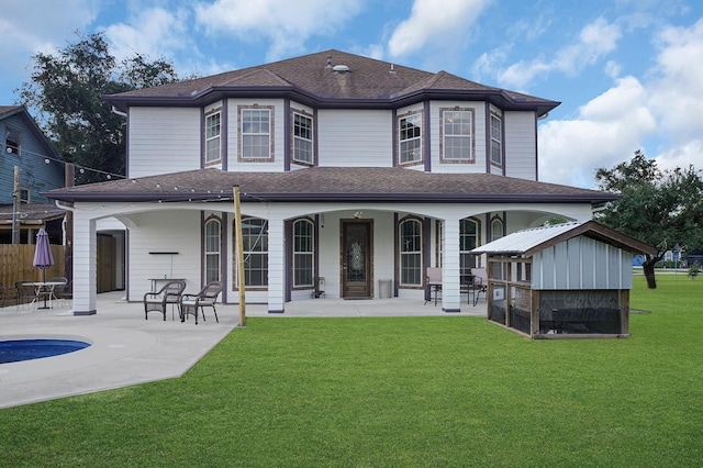 rear view of property featuring a patio and a lawn