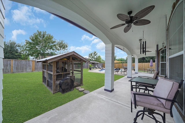 view of patio / terrace featuring ceiling fan and an outdoor structure