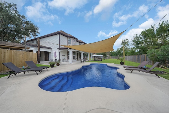 view of pool featuring a yard and a patio