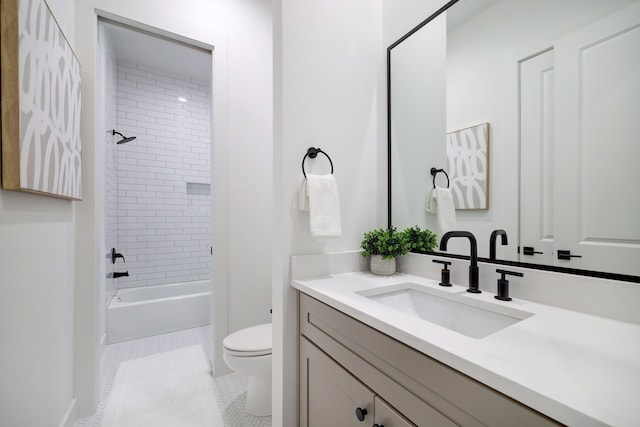 full bathroom with vanity, tiled shower / bath, tile patterned floors, and toilet