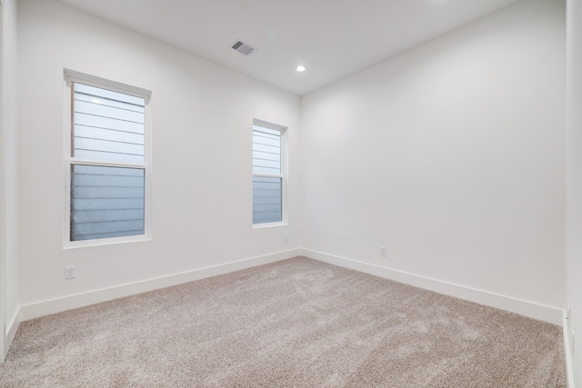 empty room featuring light colored carpet