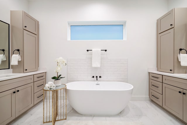 bathroom with vanity and a tub