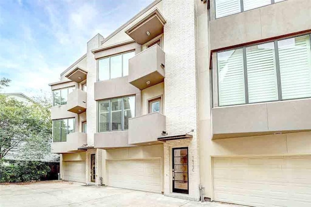 exterior space with an attached garage and stucco siding