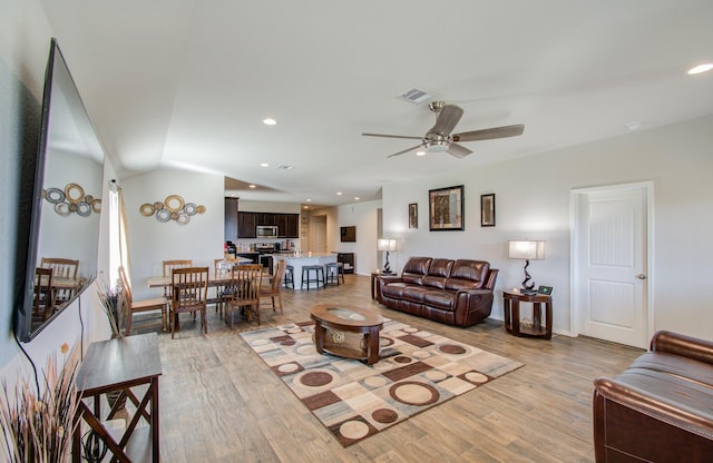 living room featuring ceiling fan and light wood-type flooring