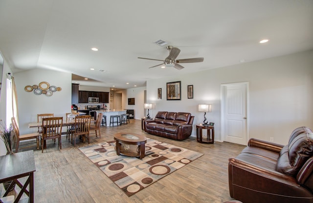 living room featuring light wood-type flooring and ceiling fan