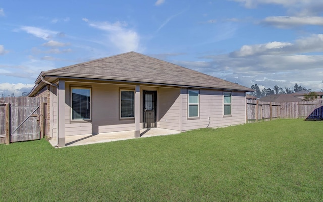 rear view of property with a patio area and a lawn