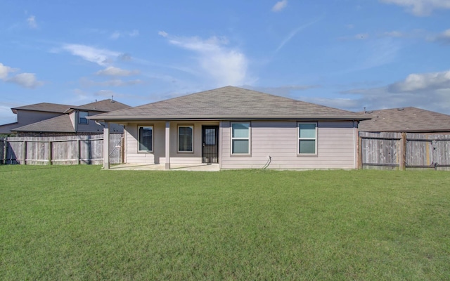 rear view of property with a lawn and a patio area