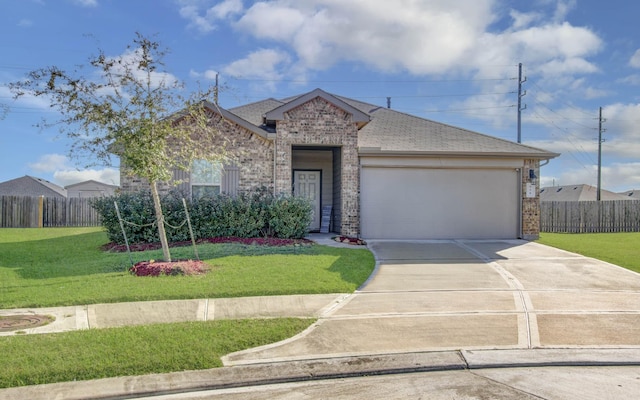 view of front facade with a front yard and a garage