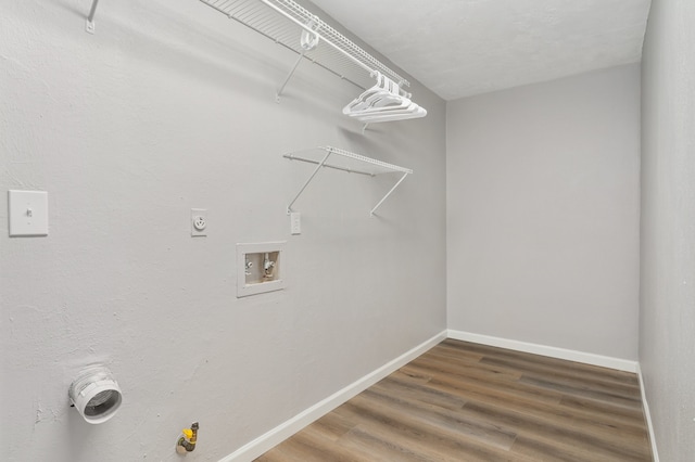 washroom featuring washer hookup, gas dryer hookup, and dark hardwood / wood-style flooring