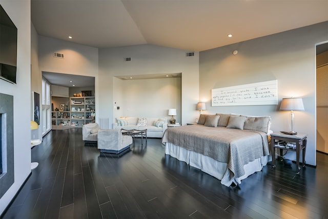 bedroom with high vaulted ceiling and dark wood-type flooring