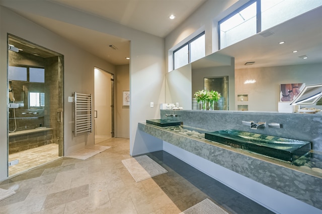 bathroom featuring radiator and an enclosed shower