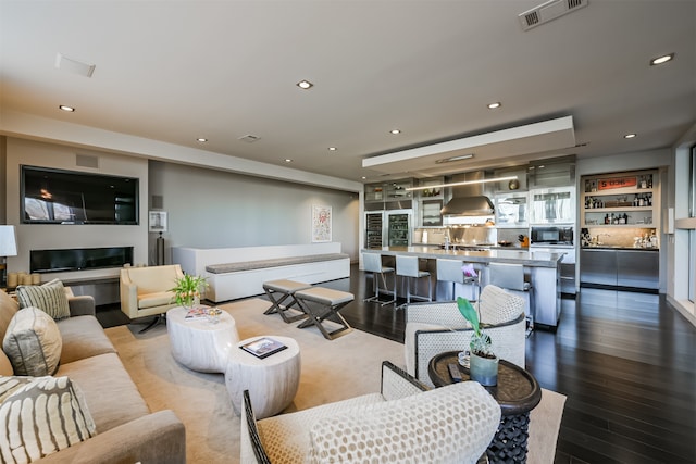 living room with wood-type flooring and a fireplace