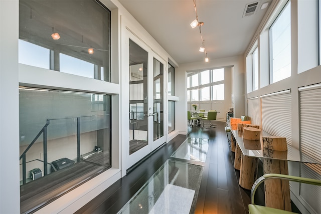 sunroom / solarium featuring french doors