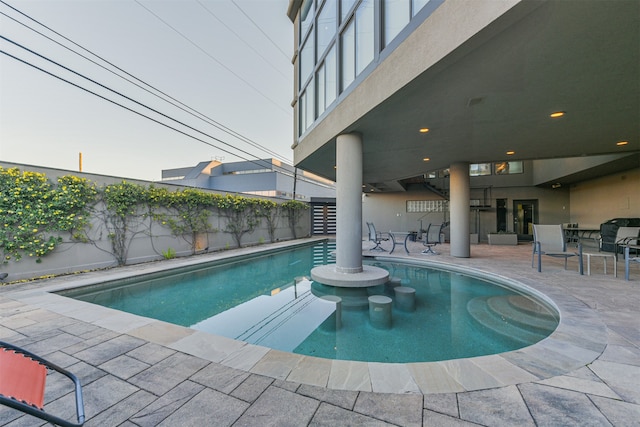 view of swimming pool featuring a patio area