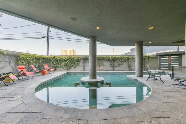 view of swimming pool with a patio