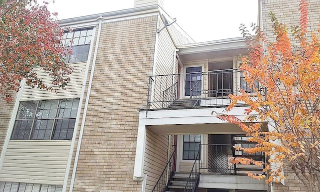 view of side of home with a balcony