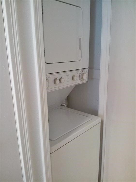 laundry room with stacked washer / drying machine