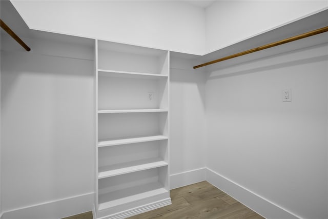 walk in closet with hardwood / wood-style floors