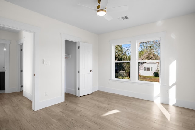 unfurnished bedroom with ceiling fan and light hardwood / wood-style flooring