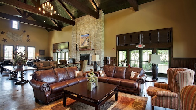 living room featuring beamed ceiling, wood ceiling, a fireplace, and high vaulted ceiling